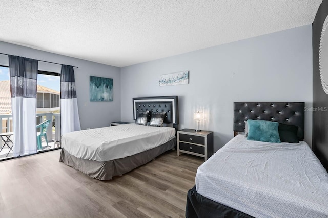 609 Lively Dr Unit B, Sun City Center, FL 33573 - bedroom with wood finished floors, a textured ceiling, and access to exterior