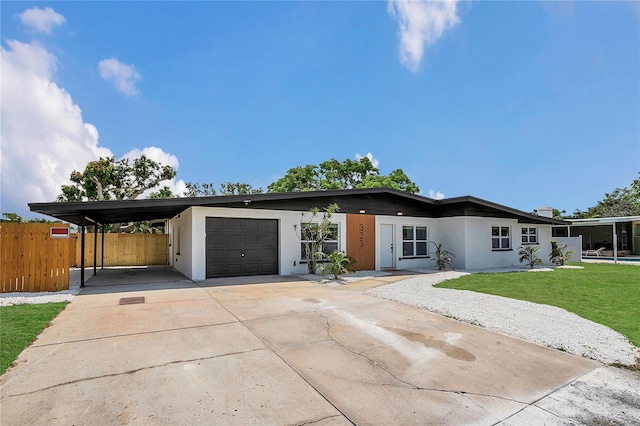 323 48th St NW, Bradenton, FL 34209 - view of front of property with an attached garage, a carport, concrete driveway, and stucco siding