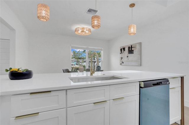 323 48th St NW, Bradenton, FL 34209 - kitchen featuring dishwashing machine, a sink, light countertops, and white cabinetry