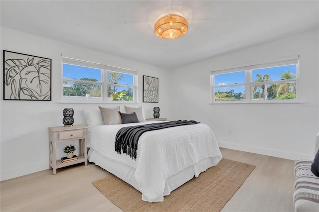 323 48th St NW, Bradenton, FL 34209 - bedroom with multiple windows, light wood-style floors, and baseboards