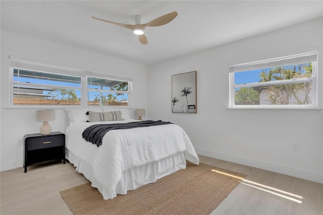 323 48th St NW, Bradenton, FL 34209 - bedroom with wood finished floors, multiple windows, ceiling fan, and baseboards