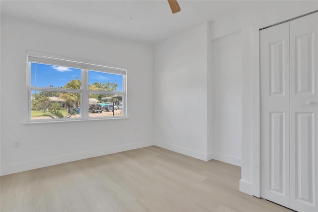 323 48th St NW, Bradenton, FL 34209 - empty room with light wood-style flooring, a ceiling fan, and baseboards