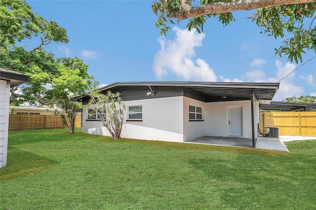 323 48th St NW, Bradenton, FL 34209 - back of house featuring a patio area, central AC unit, stucco siding, and a carport
