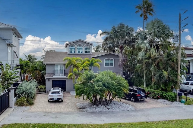 803 Harbor Dr, Belleair Beach, FL 33786 - view of front of property with stucco siding, driveway, a garage, and a balcony