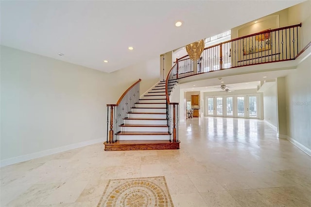803 Harbor Dr, Belleair Beach, FL 33786 - stairs featuring baseboards, recessed lighting, a ceiling fan, a high ceiling, and a chandelier
