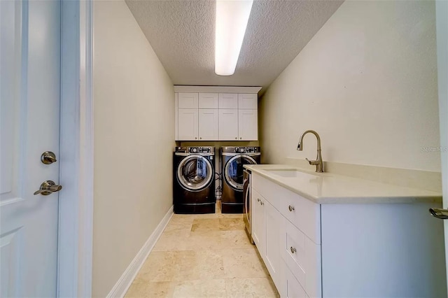 803 Harbor Dr, Belleair Beach, FL 33786 - laundry room featuring cabinet space, washing machine and dryer, a textured ceiling, and baseboards
