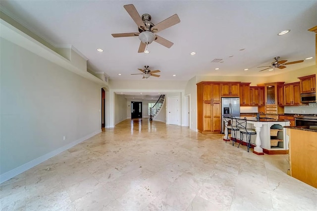 803 Harbor Dr, Belleair Beach, FL 33786 - kitchen with stainless steel appliances, ceiling fan, arched walkways, a sink, and recessed lighting