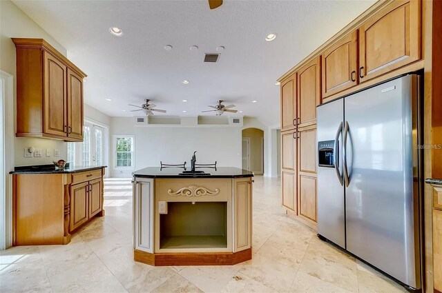 803 Harbor Dr, Belleair Beach, FL 33786 - kitchen with stainless steel fridge with ice dispenser, recessed lighting, ceiling fan, an island with sink, and arched walkways