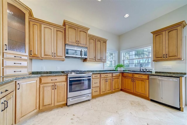 803 Harbor Dr, Belleair Beach, FL 33786 - kitchen featuring stainless steel appliances, a sink, dark stone countertops, glass insert cabinets, and recessed lighting