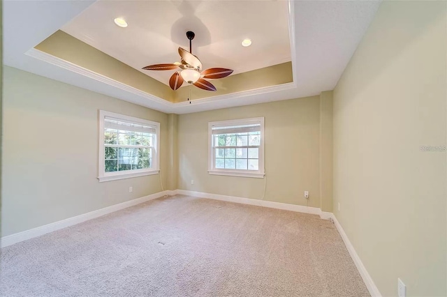 803 Harbor Dr, Belleair Beach, FL 33786 - empty room with a tray ceiling, light colored carpet, a ceiling fan, baseboards, and recessed lighting