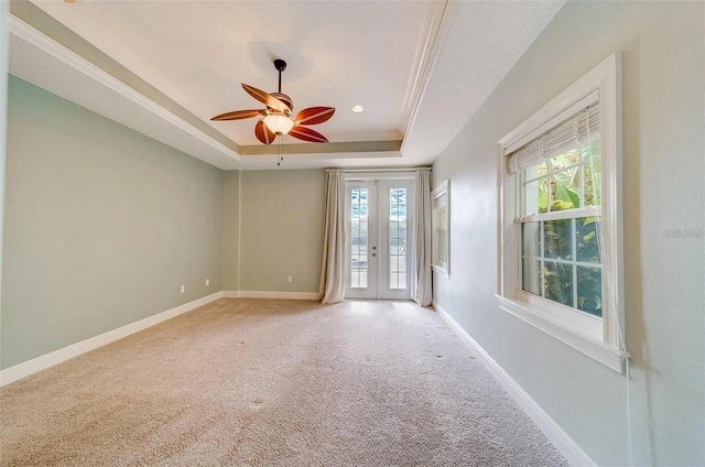 803 Harbor Dr, Belleair Beach, FL 33786 - spare room featuring a tray ceiling, light colored carpet, baseboards, and ceiling fan
