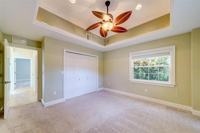 803 Harbor Dr, Belleair Beach, FL 33786 - unfurnished bedroom featuring a raised ceiling, light colored carpet, baseboards, a closet, and recessed lighting