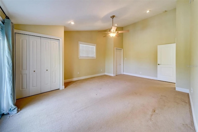 803 Harbor Dr, Belleair Beach, FL 33786 - unfurnished bedroom featuring vaulted ceiling, light carpet, baseboards, multiple closets, and a ceiling fan