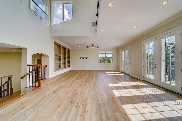 803 Harbor Dr, Belleair Beach, FL 33786 - unfurnished living room featuring french doors, light wood-type flooring, built in features, crown molding, and recessed lighting
