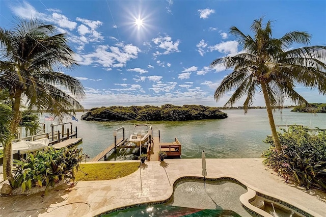 803 Harbor Dr, Belleair Beach, FL 33786 - dock area with boat lift, a water view, a patio area, and an outdoor pool