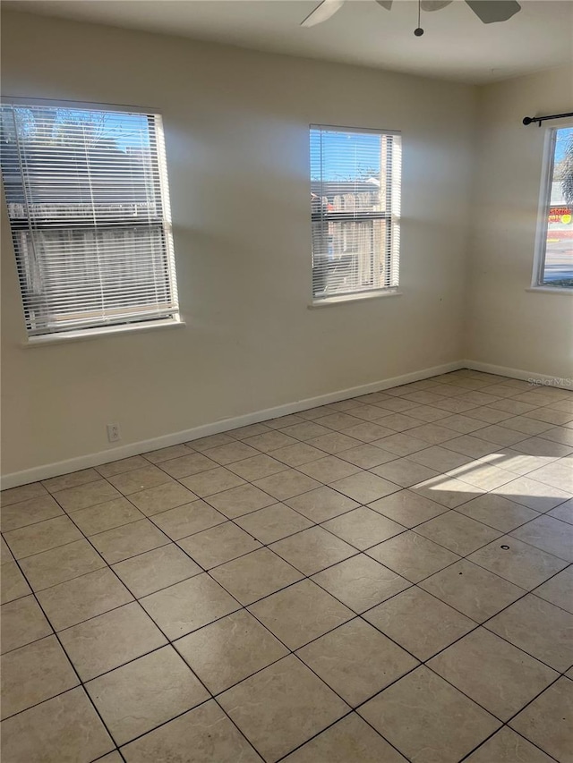 6220 Massachusetts Ave, New Port Richey, FL 34653 - spare room featuring tile patterned floors, a ceiling fan, and baseboards