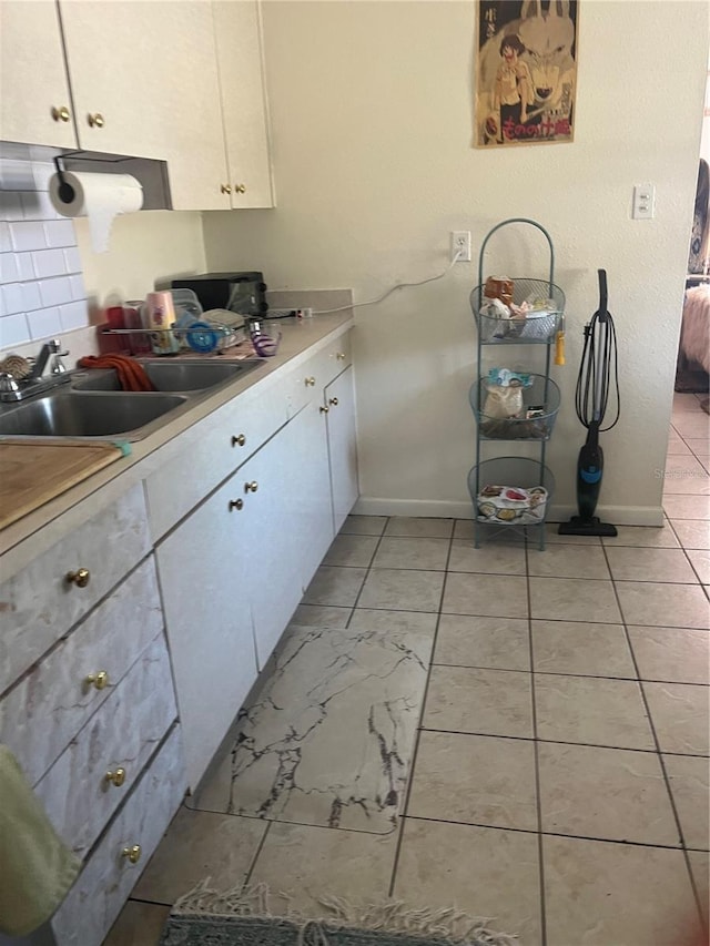 6220 Massachusetts Ave, New Port Richey, FL 34653 - kitchen with a sink, light countertops, white cabinets, and baseboards