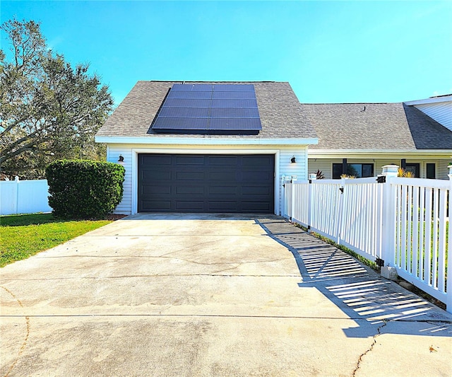 1608 20th Ave W, Palmetto, FL 34221 - view of front of home with solar panels, a garage, driveway, and a shingled roof