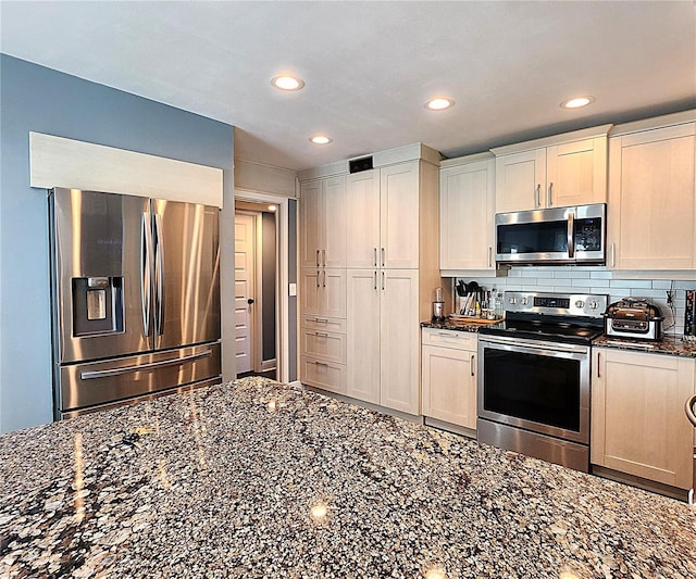 1608 20th Ave W, Palmetto, FL 34221 - kitchen featuring stainless steel appliances, recessed lighting, dark stone counters, and decorative backsplash