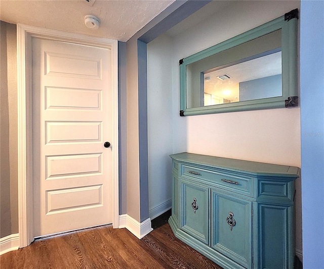 1608 20th Ave W, Palmetto, FL 34221 - hallway featuring dark wood-style floors and baseboards