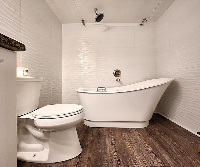 1608 20th Ave W, Palmetto, FL 34221 - bathroom with tile walls, a soaking tub, wood finished floors, and toilet