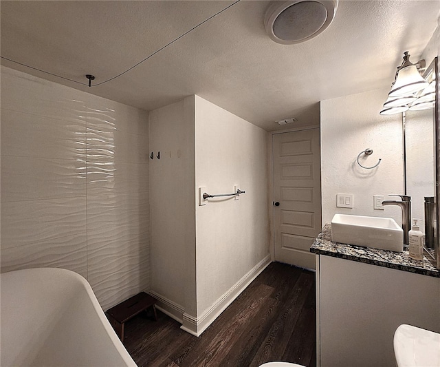 1608 20th Ave W, Palmetto, FL 34221 - full bath featuring wood finished floors, vanity, a freestanding bath, baseboards, and toilet