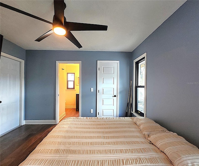 1608 20th Ave W, Palmetto, FL 34221 - bedroom with dark wood finished floors, multiple windows, ensuite bath, and baseboards