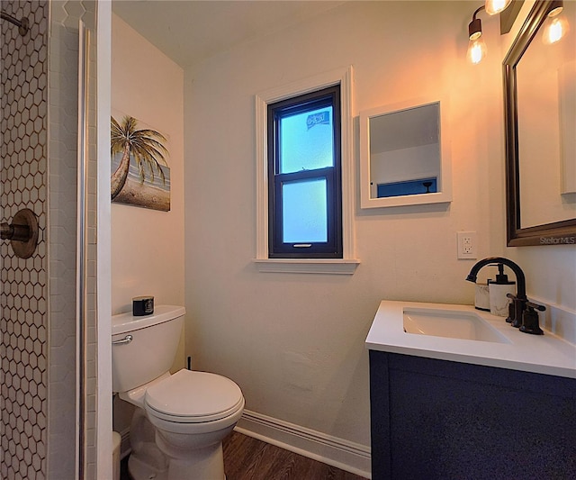 1608 20th Ave W, Palmetto, FL 34221 - full bathroom featuring toilet, vanity, tiled shower, wood finished floors, and baseboards