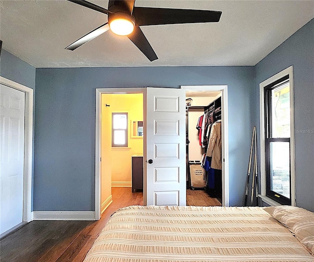 1608 20th Ave W, Palmetto, FL 34221 - bedroom with wood finished floors, a spacious closet, baseboards, a closet, and a ceiling fan