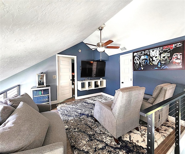 1608 20th Ave W, Palmetto, FL 34221 - living area featuring wood finished floors, ceiling fan, lofted ceiling, a textured ceiling, and baseboards