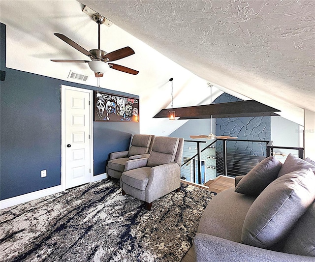 1608 20th Ave W, Palmetto, FL 34221 - living area with ceiling fan, vaulted ceiling, a textured ceiling, and baseboards