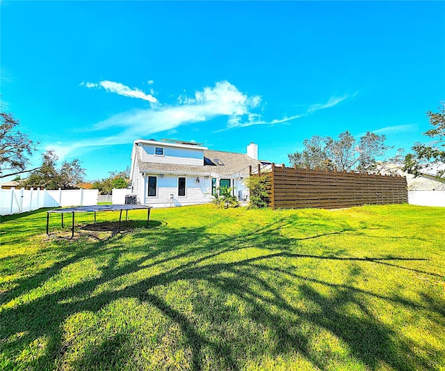 1608 20th Ave W, Palmetto, FL 34221 - back of property with a trampoline and a chimney