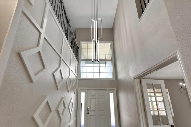 7732 Bulls Head Dr, Wesley Chapel, FL 33545 - entrance foyer with a high ceiling, healthy amount of natural light, and a textured wall