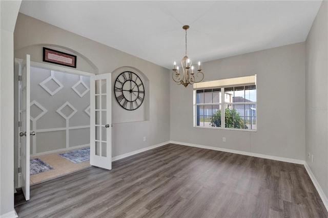 7732 Bulls Head Dr, Wesley Chapel, FL 33545 - unfurnished room with wood finished floors, a chandelier, baseboards, and french doors