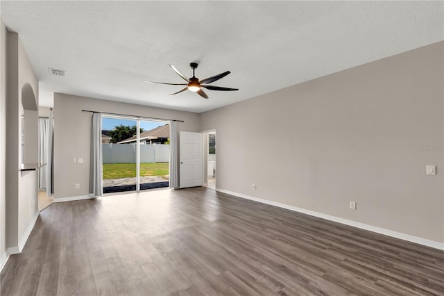 7732 Bulls Head Dr, Wesley Chapel, FL 33545 - empty room featuring a ceiling fan, dark wood-style floors, and baseboards