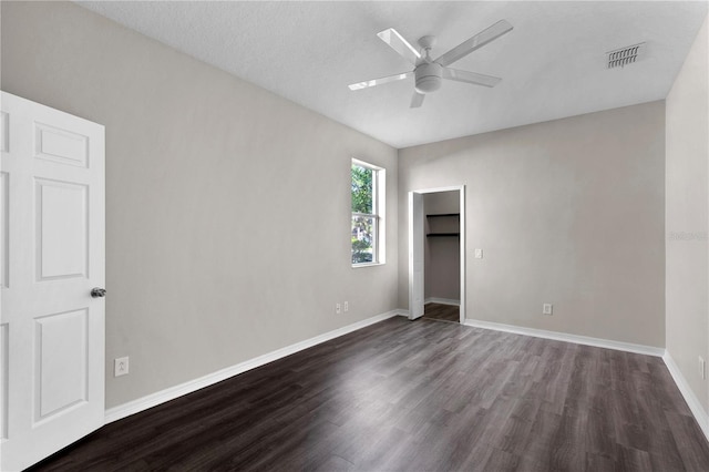 7732 Bulls Head Dr, Wesley Chapel, FL 33545 - unfurnished bedroom with dark wood-style flooring, baseboards, a closet, and ceiling fan