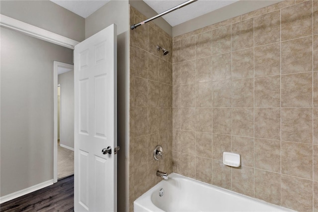 7732 Bulls Head Dr, Wesley Chapel, FL 33545 - full bathroom featuring  shower combination, wood finished floors, and baseboards