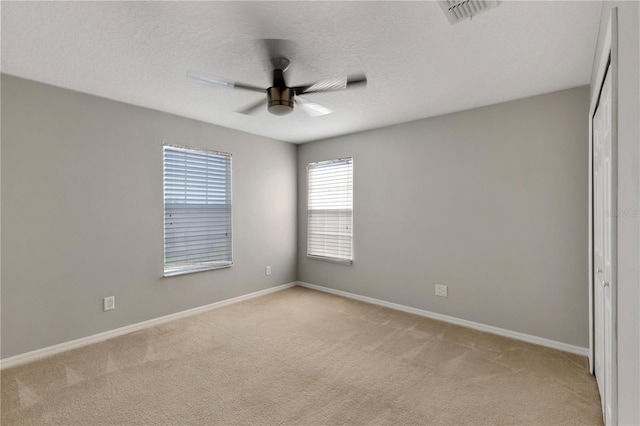 7732 Bulls Head Dr, Wesley Chapel, FL 33545 - unfurnished room featuring light colored carpet, a ceiling fan, baseboards, and a textured ceiling