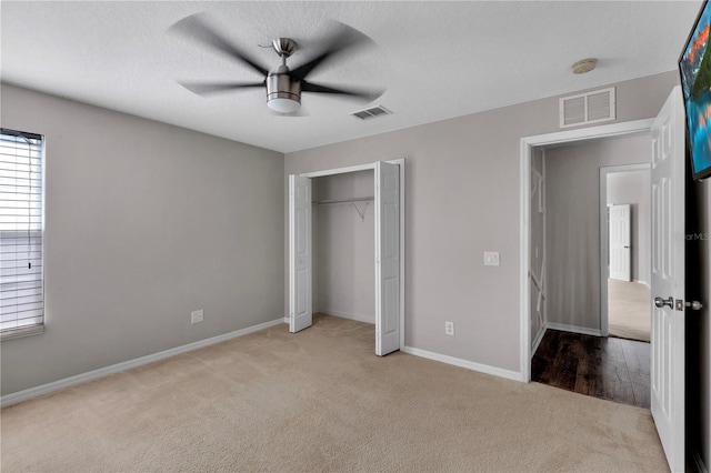 7732 Bulls Head Dr, Wesley Chapel, FL 33545 - unfurnished bedroom with light carpet, baseboards, a closet, and ceiling fan