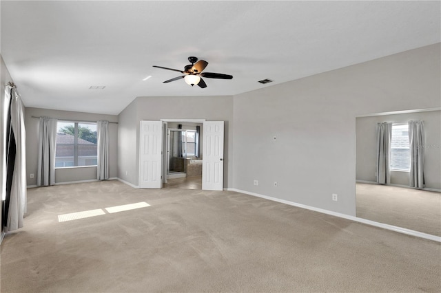 7732 Bulls Head Dr, Wesley Chapel, FL 33545 - unfurnished bedroom featuring light colored carpet, baseboards, ensuite bathroom, a ceiling fan, and lofted ceiling