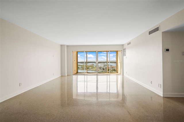 10355 Paradise Blvd Unit 1003, Treasure Island, FL 33706 - spare room with baseboards and speckled floor