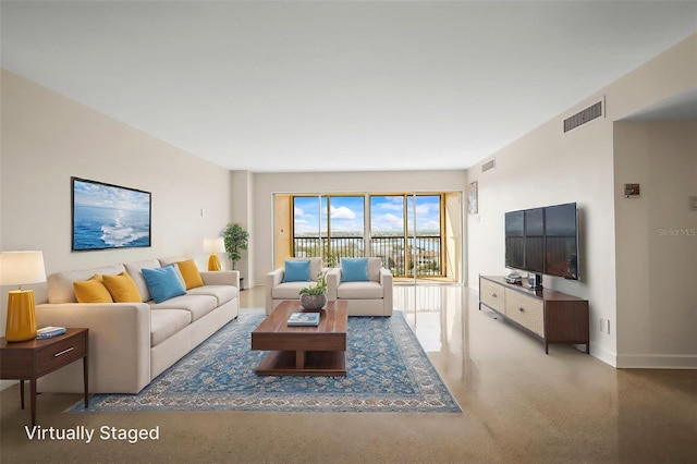 10355 Paradise Blvd Unit 1003, Treasure Island, FL 33706 - living room featuring baseboards