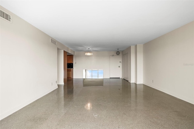 10355 Paradise Blvd Unit 1003, Treasure Island, FL 33706 - spare room with speckle patterned floor and baseboards