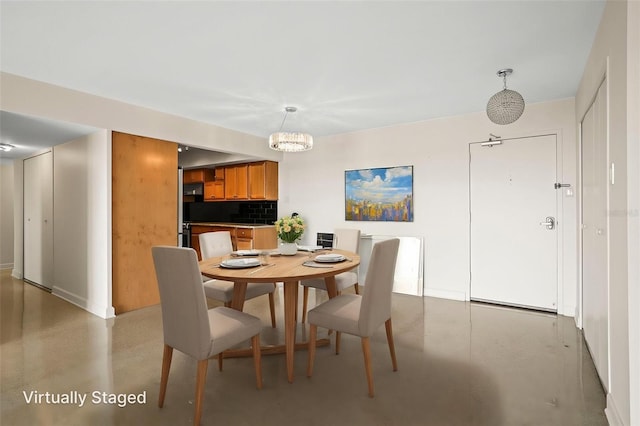 10355 Paradise Blvd Unit 1003, Treasure Island, FL 33706 - dining space with concrete floors, a chandelier, and baseboards