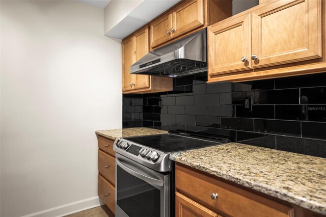 10355 Paradise Blvd Unit 1003, Treasure Island, FL 33706 - kitchen with under cabinet range hood, electric stove, tasteful backsplash, and baseboards