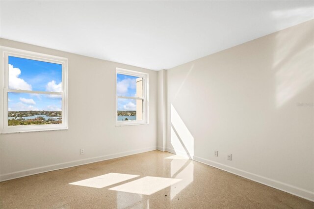 10355 Paradise Blvd Unit 1003, Treasure Island, FL 33706 - empty room with healthy amount of natural light and baseboards