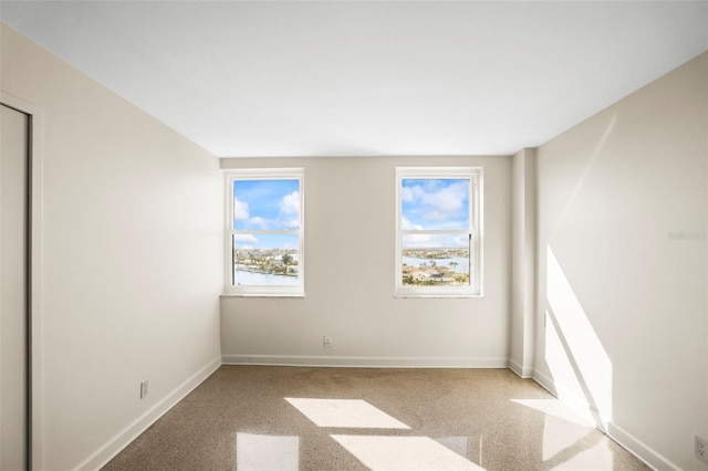 10355 Paradise Blvd Unit 1003, Treasure Island, FL 33706 - carpeted spare room with healthy amount of natural light and baseboards