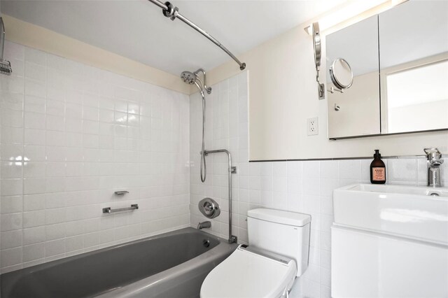 10355 Paradise Blvd Unit 1003, Treasure Island, FL 33706 - bathroom featuring shower / bath combination, vanity, toilet, tile walls, and pet washing area