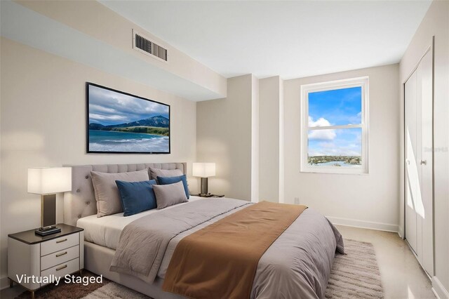 10355 Paradise Blvd Unit 1003, Treasure Island, FL 33706 - bedroom featuring baseboards and light carpet