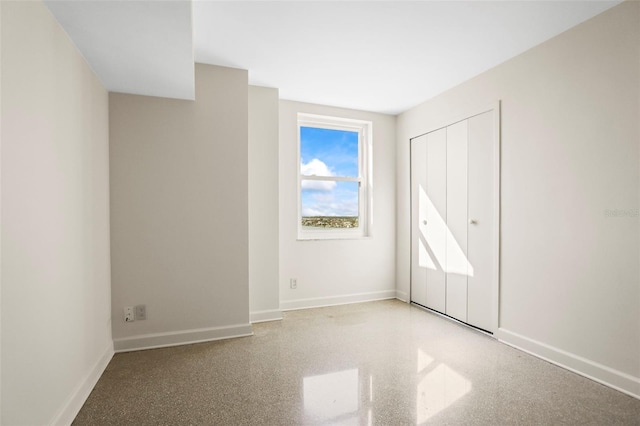 10355 Paradise Blvd Unit 1003, Treasure Island, FL 33706 - unfurnished bedroom with baseboards and a closet